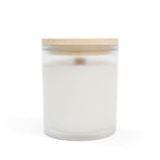 White candle in a glass jar with a wooden lid on a white background