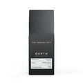 Black coffee packaging with 'The Modern Den' branding on a white background